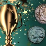 An ancient Iberian coin and an ancient Punic coin beside a trophy with star-shaped confetti.