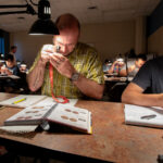People grading coins