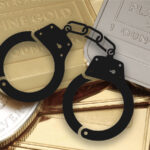 A pair of handcuffs and gold and silver bars