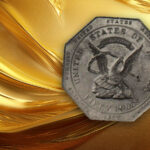 A $50 Humbert slug on a gold background
