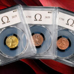 A set of 2025 Omega cents in holders against a red background