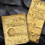 Two gold ingots with a dark grey rocky background