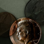 three coins on a green background